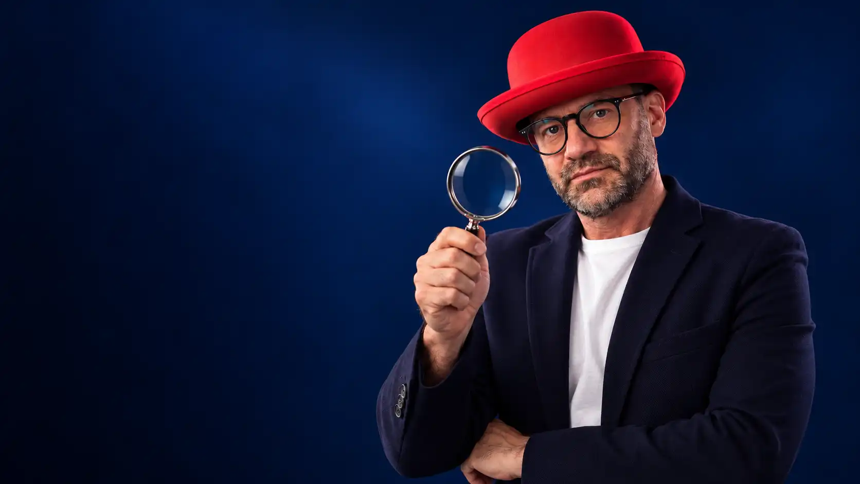 Rafał Kocik examining details through a magnifying glass